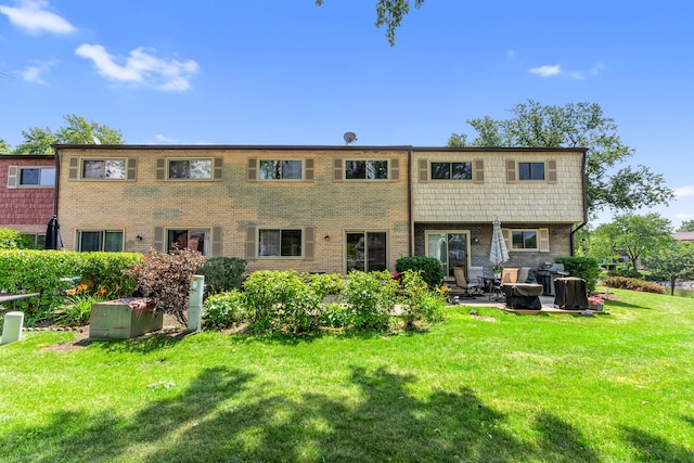 496 Navajo Trl S Unit 496, Wheeling, IL 60090 - rear view of house featuring a lawn, a patio area, and brick siding
