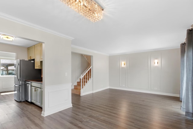 496 Navajo Trl S Unit 496, Wheeling, IL 60090 - unfurnished living room with stairway, dark wood finished floors, ornamental molding, a decorative wall, and a chandelier
