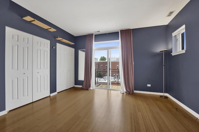 1414 S Halsted St Unit 3A, Chicago, IL 60607 - unfurnished bedroom with two closets, wood finished floors, and access to exterior