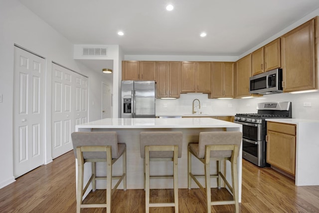 1414 S Halsted St Unit 3A, Chicago, IL 60607 - kitchen with stainless steel appliances, light countertops, light wood finished floors, a kitchen island, and recessed lighting