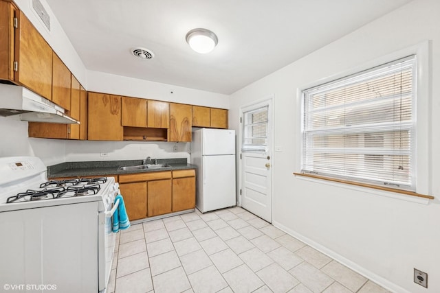 337 Wesley Ave Unit C, Oak Park, IL 60302 - kitchen with white appliances, under cabinet range hood, brown cabinetry, dark countertops, and light tile patterned floors