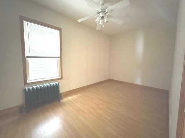 1304 S 50th Ave, Cicero, IL 60804 - unfurnished room featuring radiator heating unit, light wood-type flooring, and ceiling fan