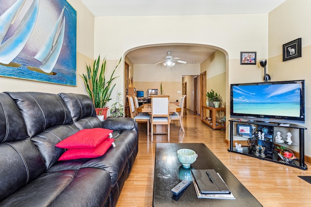 1304 S 50th Ave, Cicero, IL 60804 - living room featuring arched walkways, wood finished floors, and ceiling fan