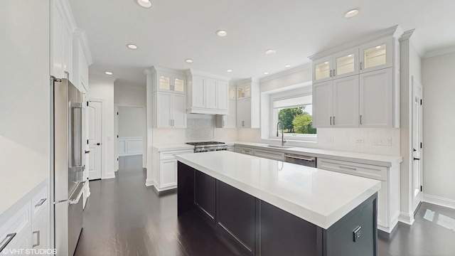 392 Spruce Rd, Wood Dale, IL 60191 - kitchen with appliances with stainless steel finishes, ornamental molding, tasteful backsplash, a center island, and white cabinetry