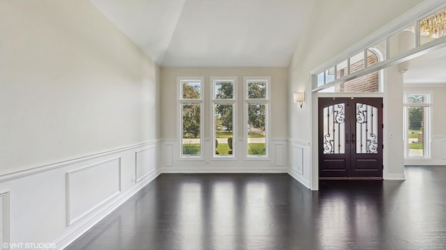 392 Spruce Rd, Wood Dale, IL 60191 - foyer with dark wood-style flooring, lofted ceiling, wainscoting, and a decorative wall