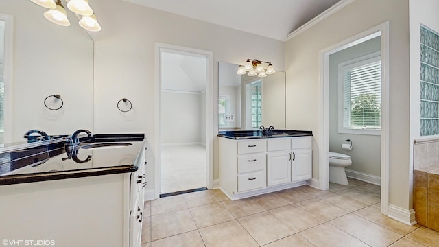 392 Spruce Rd, Wood Dale, IL 60191 - bathroom featuring a chandelier, two vanities, tile patterned floors, ornamental molding, and vaulted ceiling