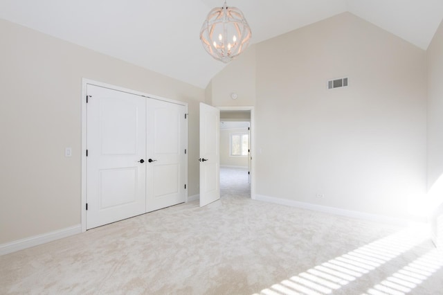 392 Spruce Rd, Wood Dale, IL 60191 - unfurnished bedroom with carpet floors, a chandelier, a closet, and high vaulted ceiling