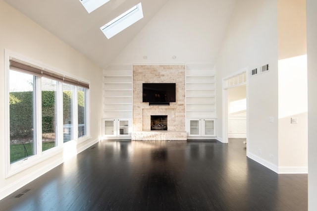 392 Spruce Rd, Wood Dale, IL 60191 - unfurnished living room with high vaulted ceiling, built in features, dark wood finished floors, a skylight, and a fireplace