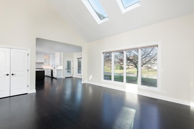 392 Spruce Rd, Wood Dale, IL 60191 - unfurnished living room featuring high vaulted ceiling, a skylight, and dark wood-type flooring