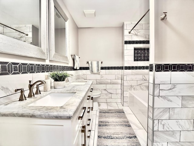 120 Walter Ct, Bloomingdale, IL 60108 - bathroom with double vanity, bathing tub / shower combination, marble finish floors, and tile walls