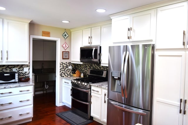 46 Copperwood Dr, Buffalo Grove, IL 60089 - kitchen featuring appliances with stainless steel finishes, decorative backsplash, light stone countertops, dark wood-style floors, and recessed lighting