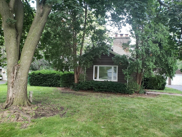 615 Polo Dr, Wheaton, IL 60187 - view of front of house with a front yard, a chimney, and a garage