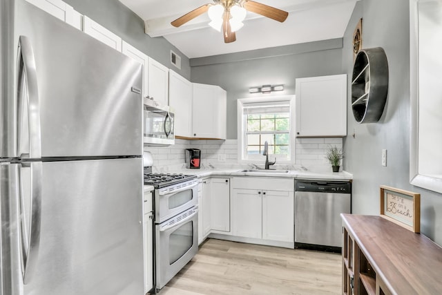 41607 N Lotus Ave, Antioch, IL 60002 - kitchen featuring appliances with stainless steel finishes, light countertops, ceiling fan, decorative backsplash, and white cabinets