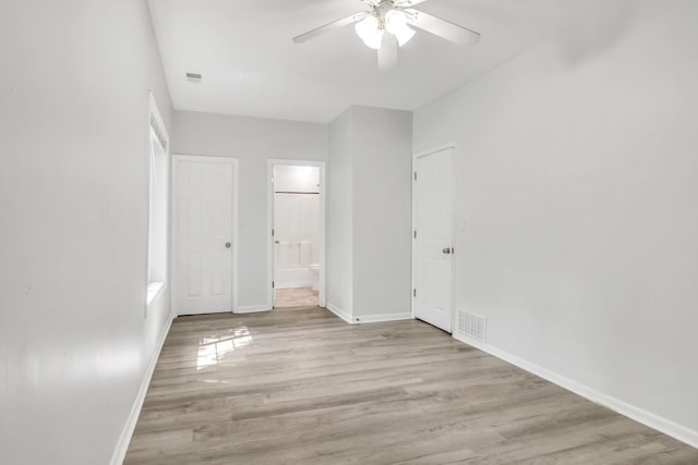 41607 N Lotus Ave, Antioch, IL 60002 - unfurnished bedroom featuring wood finished floors, connected bathroom, and ceiling fan
