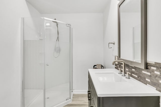 41607 N Lotus Ave, Antioch, IL 60002 - bathroom featuring vanity, a shower stall, decorative backsplash, and wood finished floors
