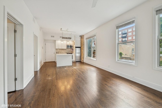 1407 N Wells St Unit 3E, Chicago, IL 60610 - unfurnished living room with plenty of natural light, dark wood-type flooring, and a ceiling fan