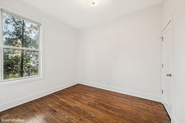 1407 N Wells St Unit 3E, Chicago, IL 60610 - spare room featuring baseboards and dark wood-type flooring
