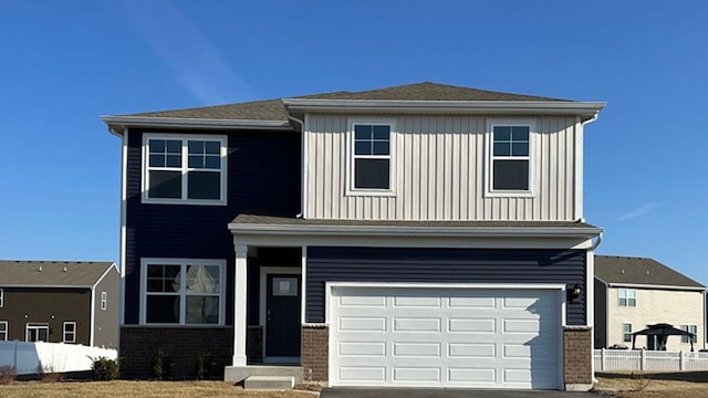2514 Winterberry Trl, Wonder Lake, IL 60097 - traditional-style home with brick siding, an attached garage, asphalt driveway, and board and batten siding