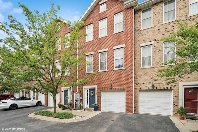 1657 Church St, Evanston, IL 60201 - view of front of home with driveway, brick siding, and an attached garage