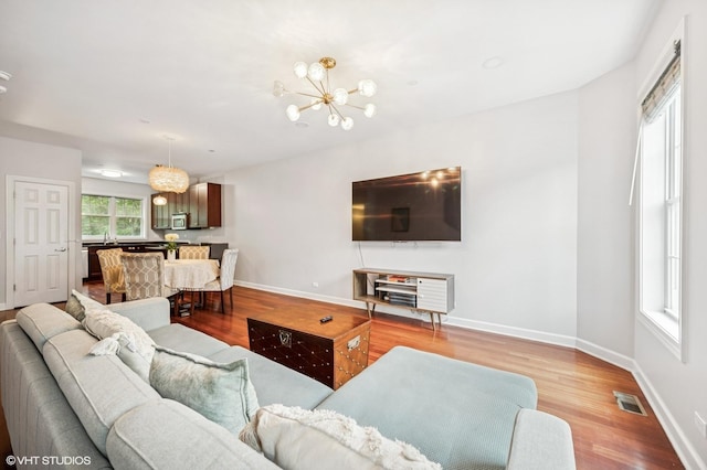 1657 Church St, Evanston, IL 60201 - living area with light wood-style floors and a chandelier