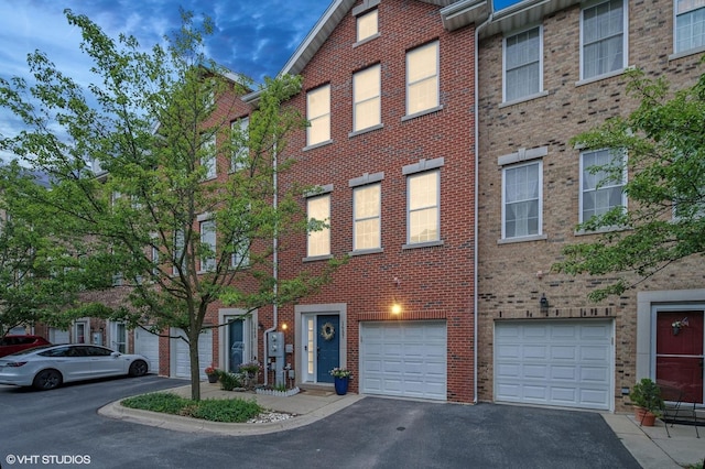 1657 Church St, Evanston, IL 60201 - view of front of house with driveway, brick siding, and a garage