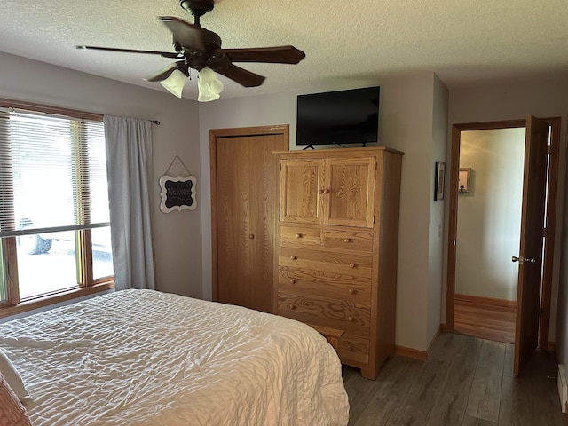 15459 Henry Rd Unit A, Morrison, IL 61270 - bedroom with light wood finished floors, a textured ceiling, multiple windows, a closet, and a ceiling fan