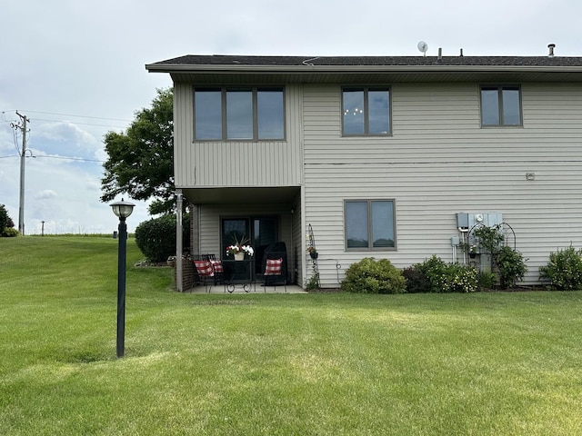 15459 Henry Rd Unit A, Morrison, IL 61270 - back of property featuring a lawn and a patio area