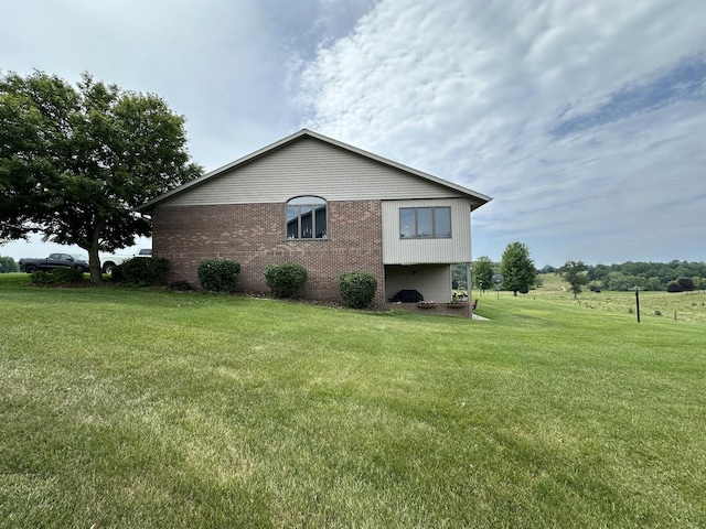 15459 Henry Rd Unit A, Morrison, IL 61270 - view of property exterior featuring brick siding and a lawn