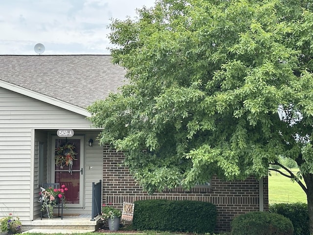 15459 Henry Rd Unit A, Morrison, IL 61270 - entrance to property with a shingled roof and brick siding