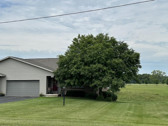 15459 Henry Rd Unit A, Morrison, IL 61270 - obstructed view of property featuring a front yard, a garage, and driveway