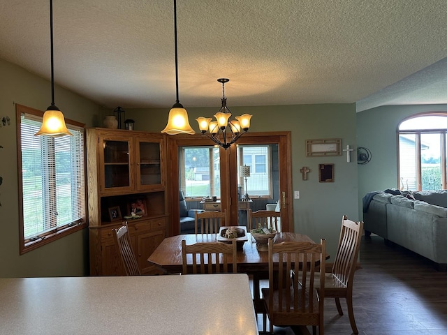 15459 Henry Rd Unit A, Morrison, IL 61270 - dining room featuring a chandelier, healthy amount of natural light, a textured ceiling, and dark wood-type flooring