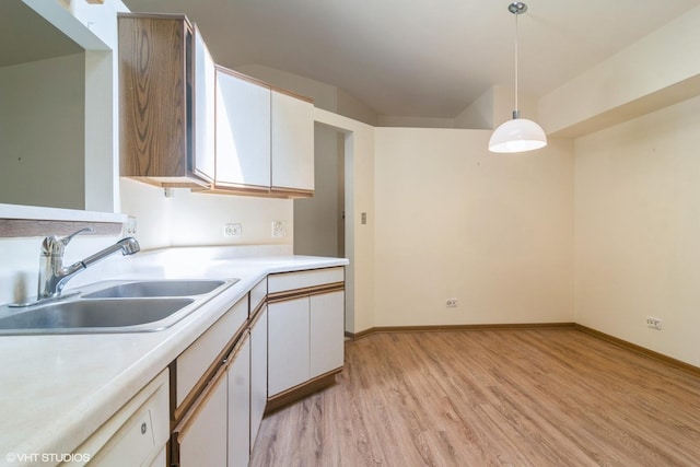 4130 N Pheasant Trail Ct Unit 2, Arlington Heights, IL 60004 - kitchen featuring light wood-style flooring, white cabinets, hanging light fixtures, and light countertops