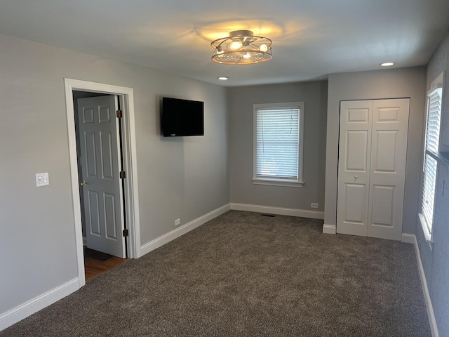7830 Westview Ln, Woodridge, IL 60517 - unfurnished bedroom featuring dark carpet, a closet, and recessed lighting