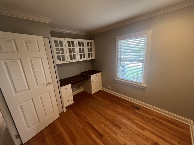 7830 Westview Ln, Woodridge, IL 60517 - unfurnished office with built in desk, dark wood finished floors, and crown molding