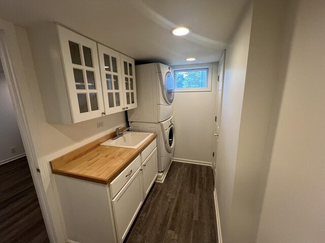 7830 Westview Ln, Woodridge, IL 60517 - washroom with estacked washer and dryer, cabinet space, and dark wood-type flooring