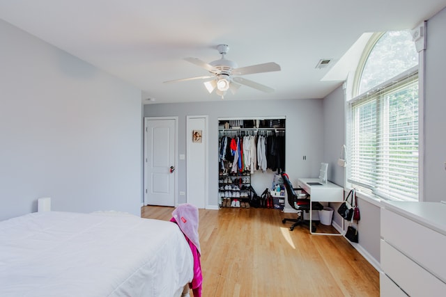 974 Webster Ln, Des Plaines, IL 60016 - bedroom featuring light wood-style flooring, a closet, a desk, and a ceiling fan