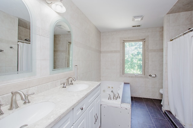 974 Webster Ln, Des Plaines, IL 60016 - bathroom with tile walls, a tub with jets, double vanity, a tile shower, and tile patterned flooring