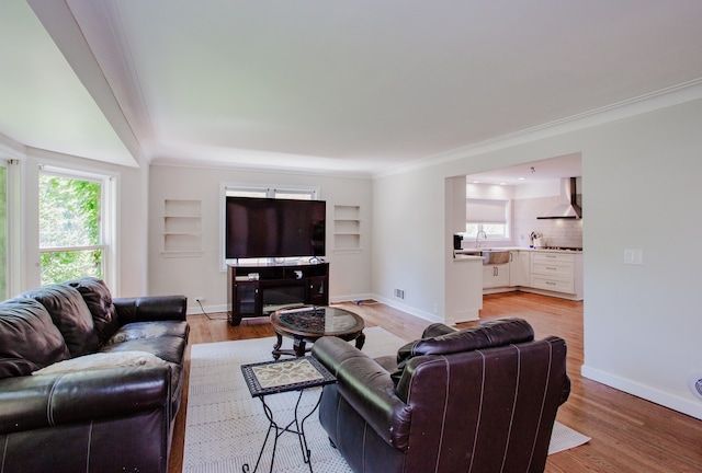 974 Webster Ln, Des Plaines, IL 60016 - living room featuring light wood-type flooring, built in shelves, and ornamental molding