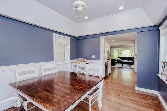 974 Webster Ln, Des Plaines, IL 60016 - dining area featuring beverage cooler, a wainscoted wall, light wood-style flooring, ceiling fan, and a decorative wall