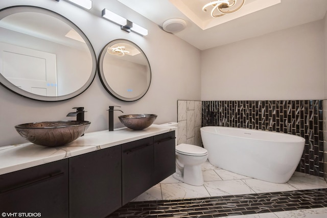 11616 S Lowe Ave, Chicago, IL 60628 - full bath with marble finish floors, double vanity, a soaking tub, and tile walls