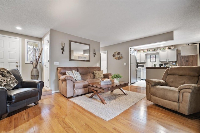 903 N Linden St Unit 131, Normal, IL 61761 - living area featuring light wood-style floors, a textured ceiling, and recessed lighting