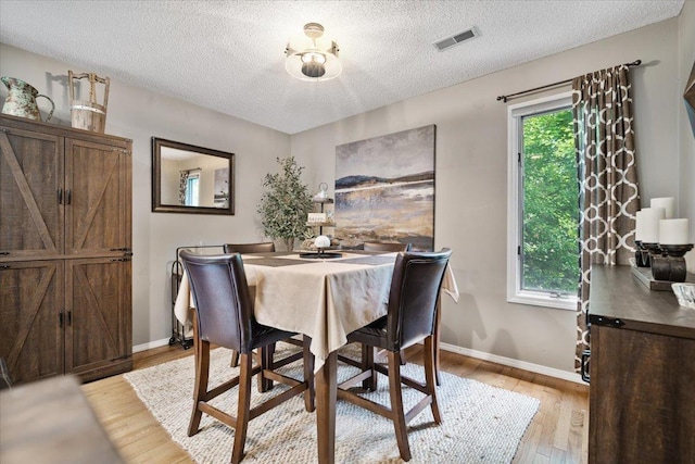 903 N Linden St Unit 131, Normal, IL 61761 - dining area with light wood-style floors and a textured ceiling