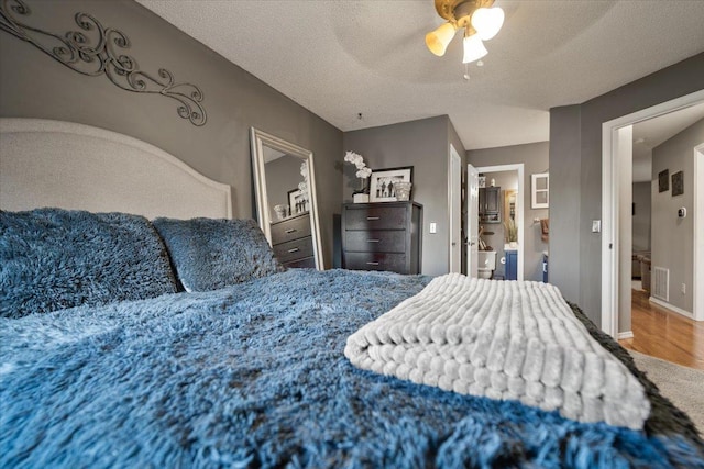 903 N Linden St Unit 131, Normal, IL 61761 - bedroom featuring wood finished floors, ceiling fan, and a textured ceiling