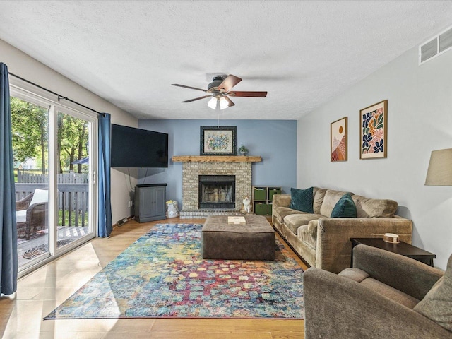 316 Harwich Pl, Rockton, IL 61072 - living area with a ceiling fan, a textured ceiling, and a brick fireplace