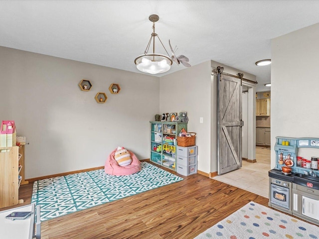 316 Harwich Pl, Rockton, IL 61072 - playroom featuring a barn door and light wood finished floors