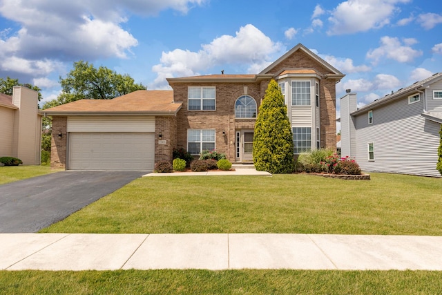 22401 Helen Dr, Sauk Village, IL 60411 - traditional-style house featuring brick siding, an attached garage, asphalt driveway, and a front yard
