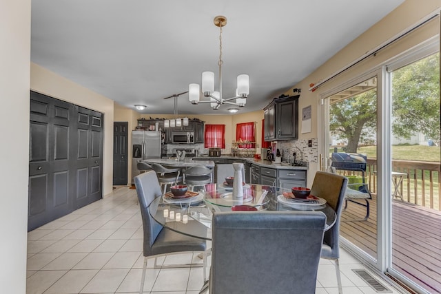 22401 Helen Dr, Sauk Village, IL 60411 - dining room featuring a chandelier and light tile patterned floors