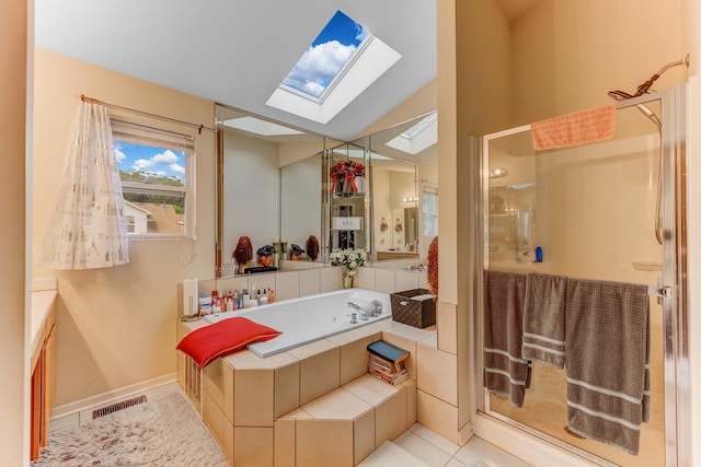 22401 Helen Dr, Sauk Village, IL 60411 - bathroom featuring a skylight, a stall shower, a bath, tile patterned floors, and vaulted ceiling