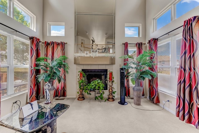 22401 Helen Dr, Sauk Village, IL 60411 - carpeted living area featuring healthy amount of natural light, a high ceiling, and a tile fireplace