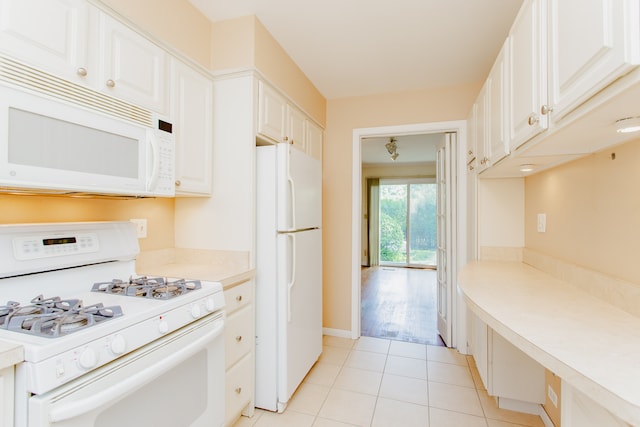 590 Green Bay Rd, Glencoe, IL 60022 - kitchen featuring white appliances, light tile patterned floors, light countertops, and white cabinetry
